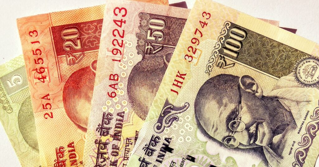 Close-up image of Indian rupee banknotes in various denominations, showcasing currency design.