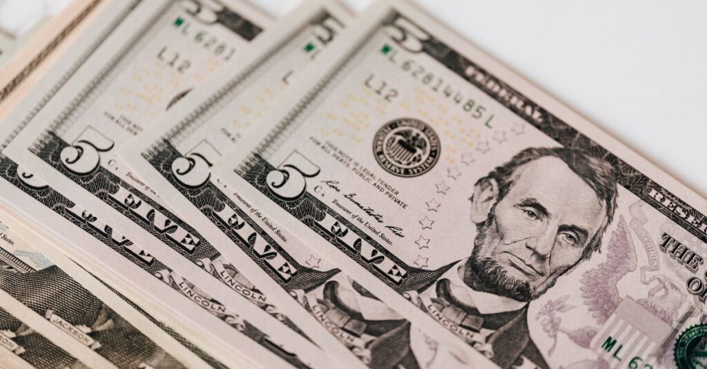 Top view of stack of US dollar banknotes placed together on white background